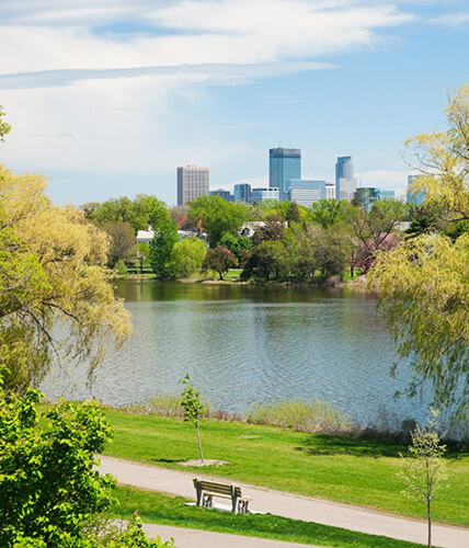 a view of the lake with the minneapolis skyline behind